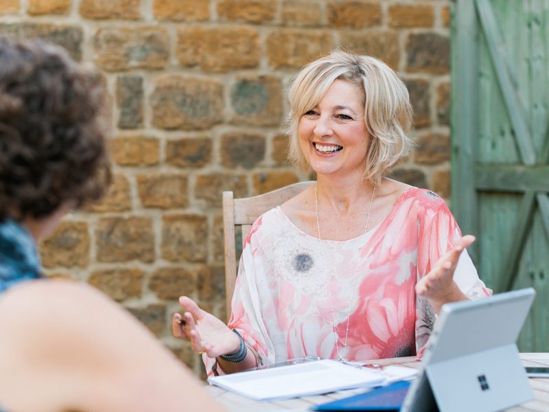 Lynne James going through papers with a client