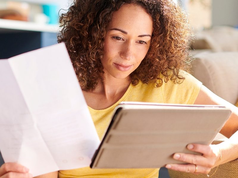 A woman reading through financial paperwork